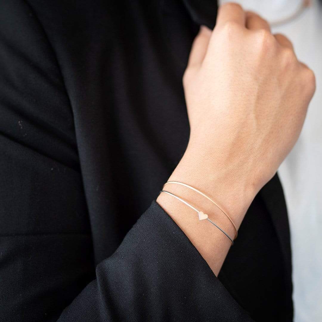 Woman wearing Thinking of You bracelet with bicolour heart charm | CLIC by Suzanne
